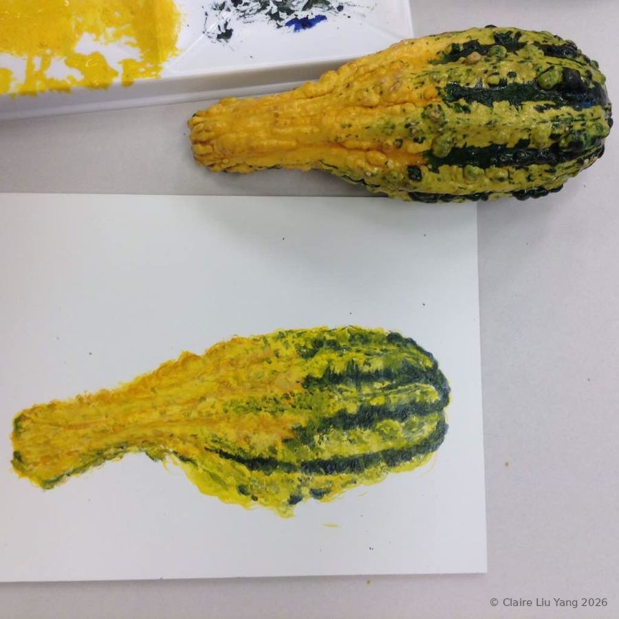 Two yellow and green striped gourds, painted beside the real one